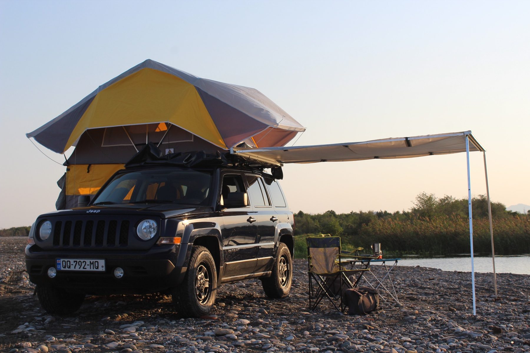 Jeep Patriot with rooftop tent and camping setup